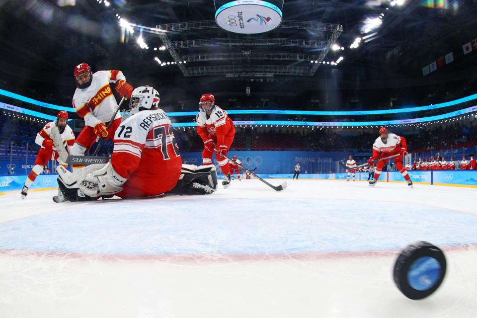 China's Lin Ni (2nd L) scores a goal during the women's preliminary round group B match of the Beijing 2022 Winter Olympic Games ice hockey competition between Denmark and China (POOL/AFP via Getty Images)