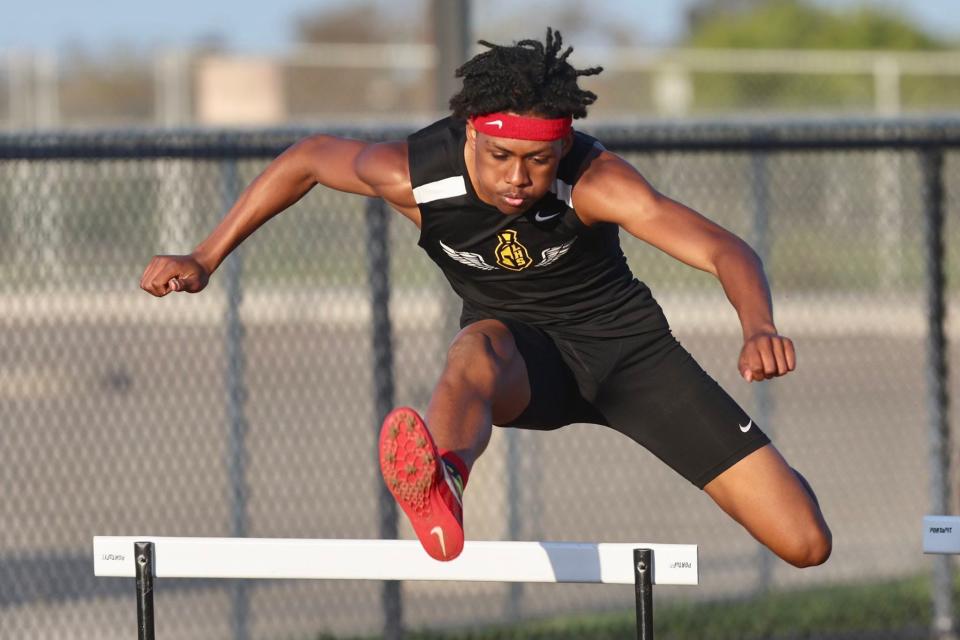 Lathrop's Adonis Siga jumps over a hurdle during one of the Spartans' track meets during the 2023-24 season.