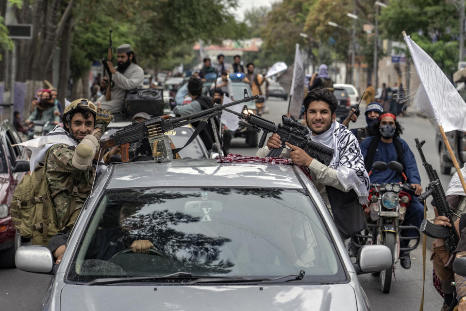 Taliban fighters parade in the streets as they celebrate one year since they seized the Afghan capital, Kabul, in Kabul, Afghanistan, Monday, Aug. 15, 2022. The Taliban marked the first-year anniversary of their takeover after the country's western-backed government fled and the Afghan military crumbled in the face of the insurgents' advance. (AP Photo/Ebrahim Noroozi)