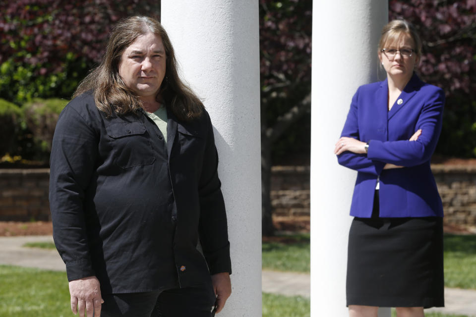 Halifax County Commonwealth's Attorney Tracy Martin, right, poses with Kevin Wynn at the Halifax County War Memorial on Wednesday May 6, 2020, in Halifax, Va. Martin has objected to the geriatric release of Debra Scribner, 66, convicted in 2012 of first-degree murder, conspiracy and a firearms charge in the death of her son-in-law, Eric Wynn, who was the brother of Kevin Wynn. A review by The Associated Press has found during a push to accelerate the review of parole-eligible inmates because of the coronavirus pandemic, Virginia released dozens of violent offenders, including killers, rapists and kidnappers, blindsiding prosecutors and victims' families who say they were not properly notified as required by law. (AP Photo/Steve Helber)