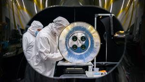 SDL engineers work on the AWE telescope in a cleanroom at SDL facilities on Utah State University's Innovation Campus. AWE’s four telescopes and aperture baffle are shown in this image. Credits: SDL/Allison Bills