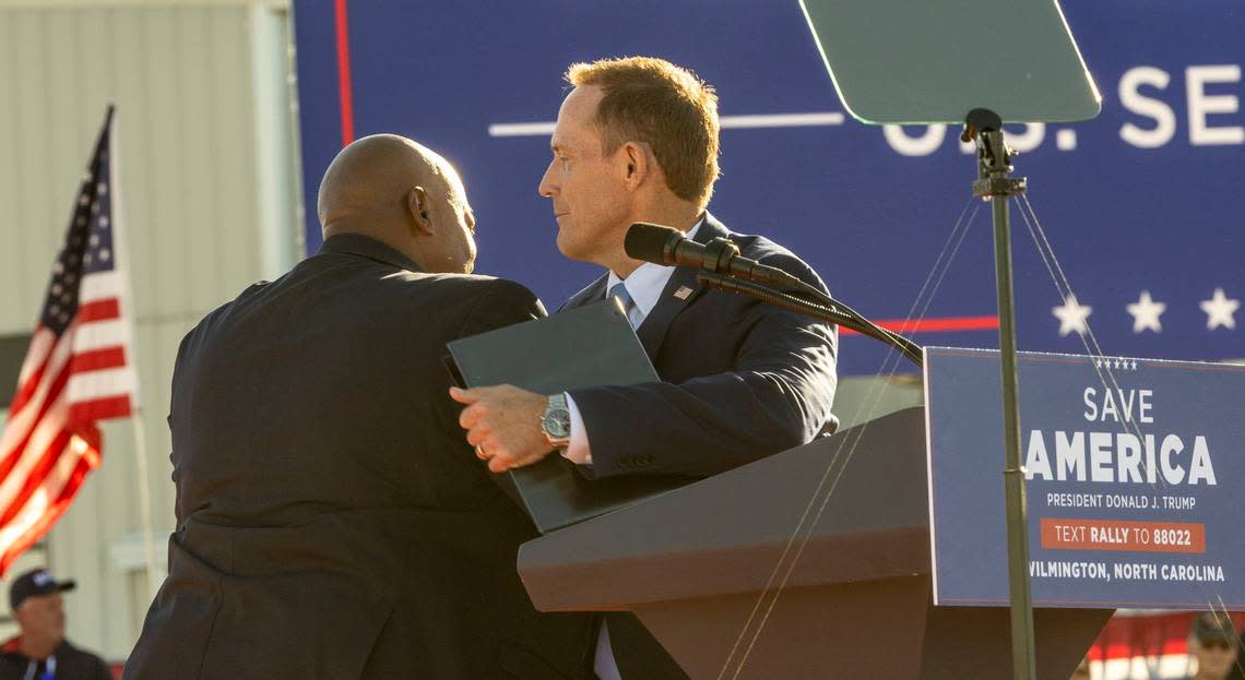 District 13 U.S. Rep. and U.S. Senate candidate Ted Budd and Lt. Gov. Mark Robinson embrace during a rally featuring former president Donald Trump at Wilmington International Airport Friday, Sept. 23, 2023.