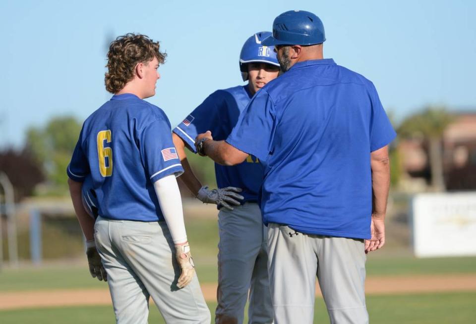 Ripon Christian coach John de Visser talks with Luke Crivello and Joshua Buffalow during a timeout during the CIF Sac-Joaquin Section Division VI championship against Leroy Greene Academy at Islander’s Park in Lathrop, Calif. on Tuesday, May 21, 2024.