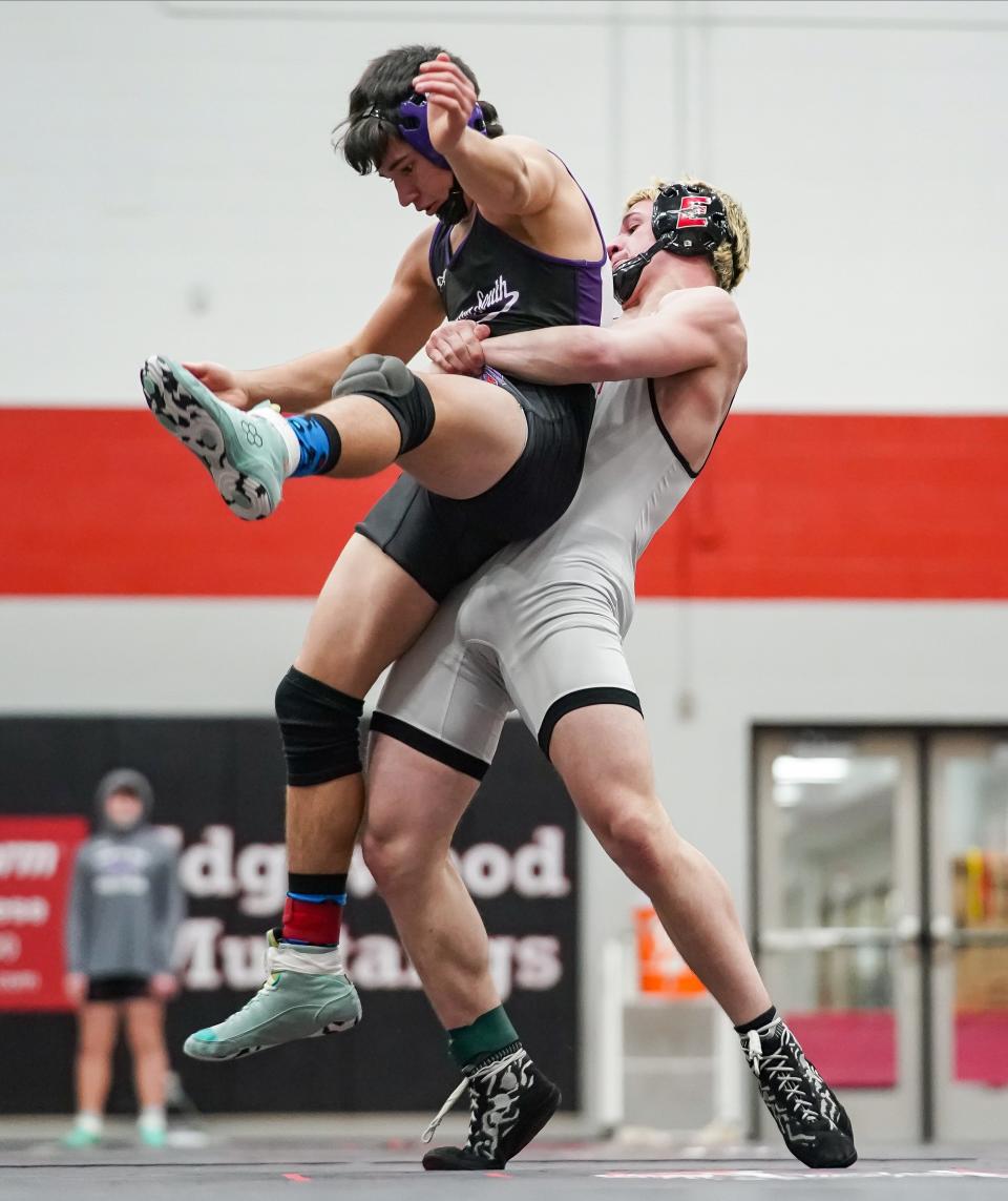 Edgewood’s Michael Neidigh (right) lifts up Bloomington South’s Carson Bohall in the 150-pound match during their dual meet at Edgewood on Thursday, Jan. 18, 2024.