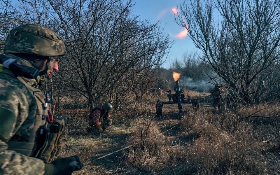 A Ukrainian soldier attacks Russian positions on the front line near Bakhmut in the Donetsk region - AP