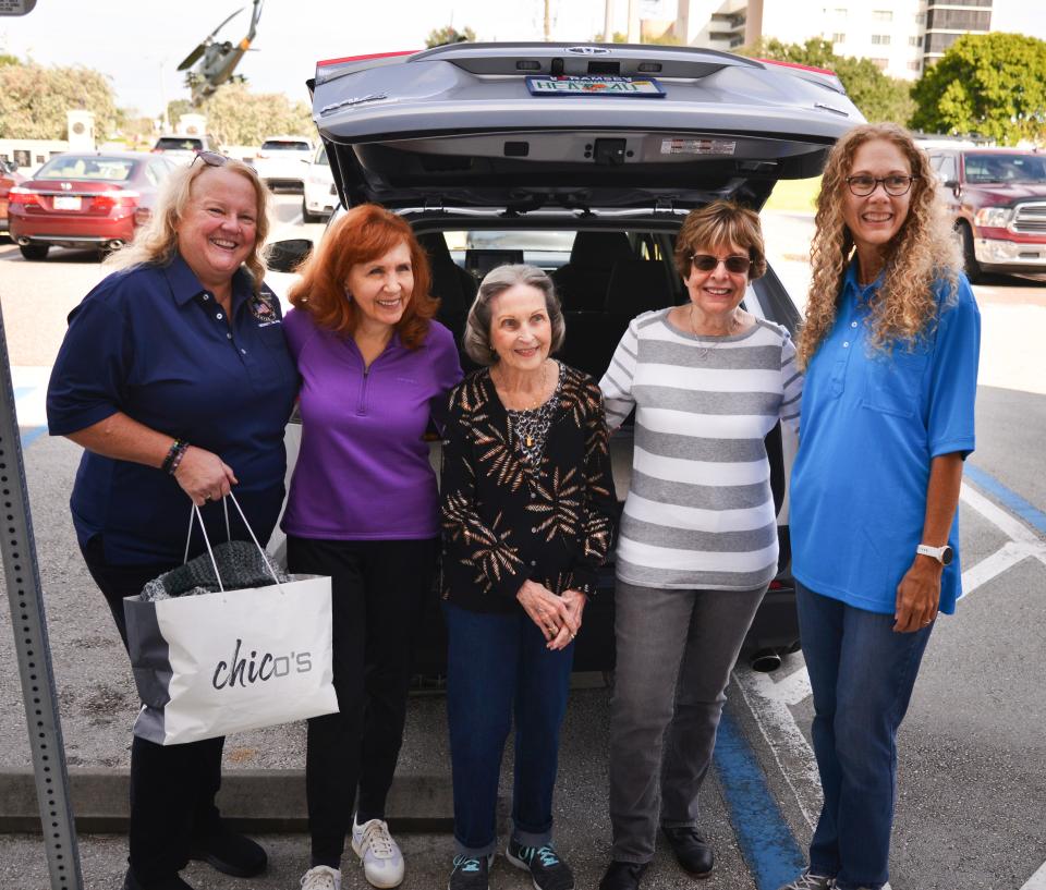 Dorothy Walsh with Their Voice of Hope, Linda Gotham, Marjorie Leonhardt and Rita Brooks, all with the Heritage Isle Crafters, and Kristi Blanchard, Veterans Memorial Center secretary, are pictured after unloading donations from the crafters at the Veterans Memorial Center on Merritt Island. The donations, including handmade knitted and crocheted scarves, hats, quilts, blankets, tissue boxes and more, will be distributed to area veterans and their families.