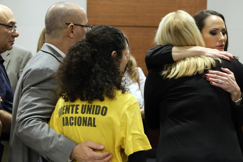 FILE - Florida Circuit Judge Elizabeth Scherer, right, hugs Jennifer Guttenberg following the sentencing hearing for Parkland school shooter Nikolas Cruz at the Broward County Courthouse in Fort Lauderdale, Fla., Nov. 2, 2022. Guttenberg's daughter, Jaime, was killed in the 2018 shootings. A state commission concluded Monday, June 5, 2023, that Scherer should be publicly reprimanded for showing bias toward the prosecution, failing to curtail “vitriolic statements” directed at his attorneys by the victims' families and sometimes “allowed her emotions to overcome her judgement.” (Amy Beth Bennett/South Florida Sun Sentinel via AP, Pool, File)