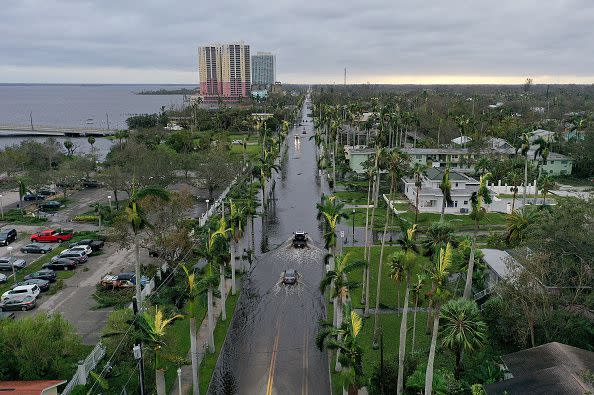 In this aerial view, vehicles make their way through a flooded area after Hurricane Ian passed through the area on September 29, 2022, in Fort Myers, Florida.
