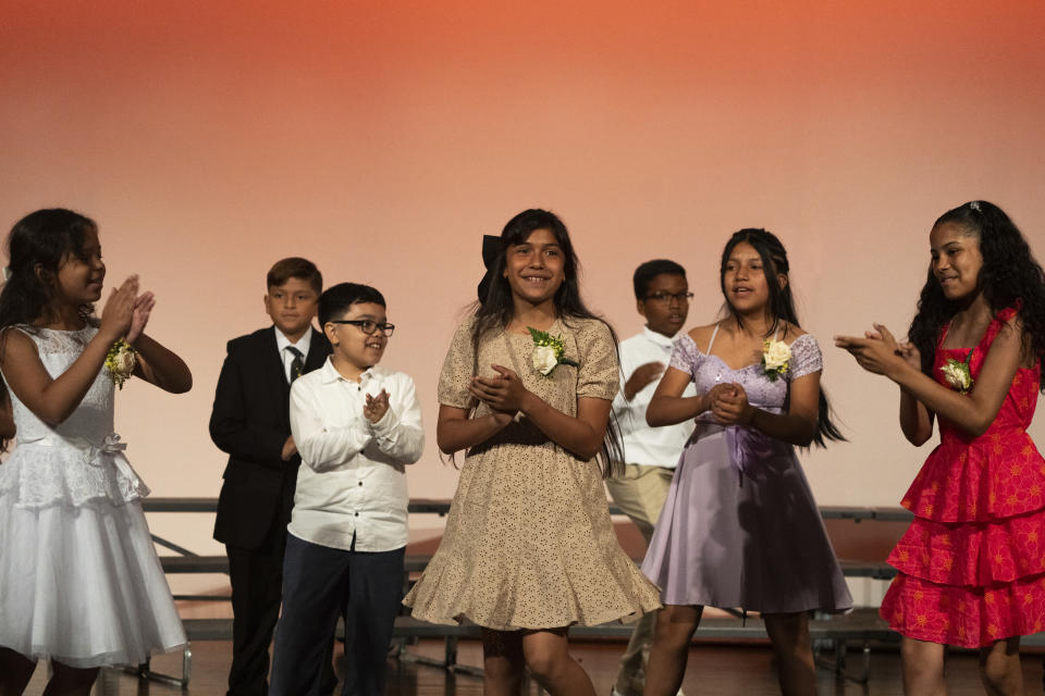 Sophia Prado, center, perfroms during a graduation ceremony at Trevor Day School, Friday, June 21, 2024 in New York. Thousands of migrant families in New York City are facing a summer of uncertainty for their school-aged children with a citywide limit of 60 days in a shelter before needing to reapply or find their own. (AP Photo/Jeenah Moon)