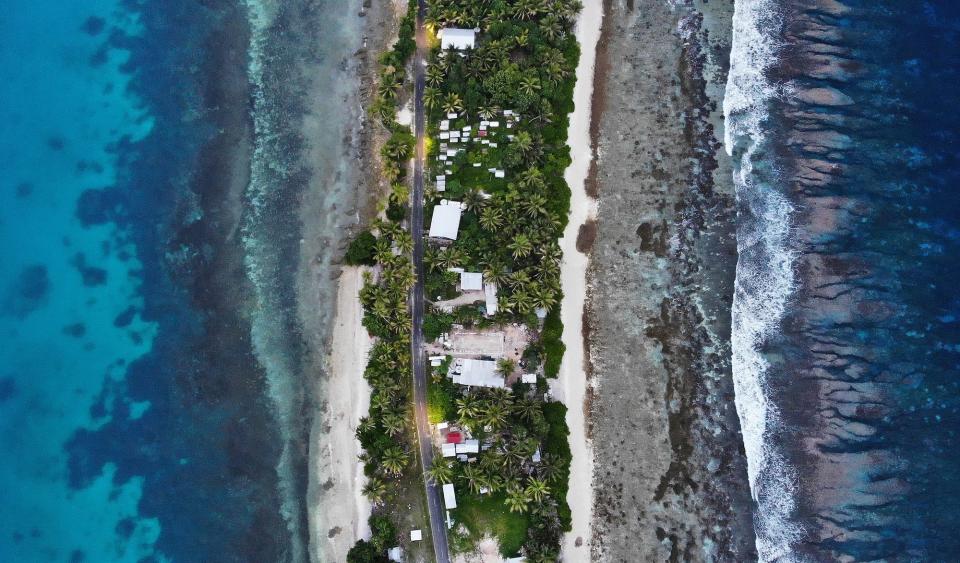 An aerial view of a strip of land between the Pacific Ocean (R) and lagoon on November 23, 2019 in Funafuti, Tuvalu.