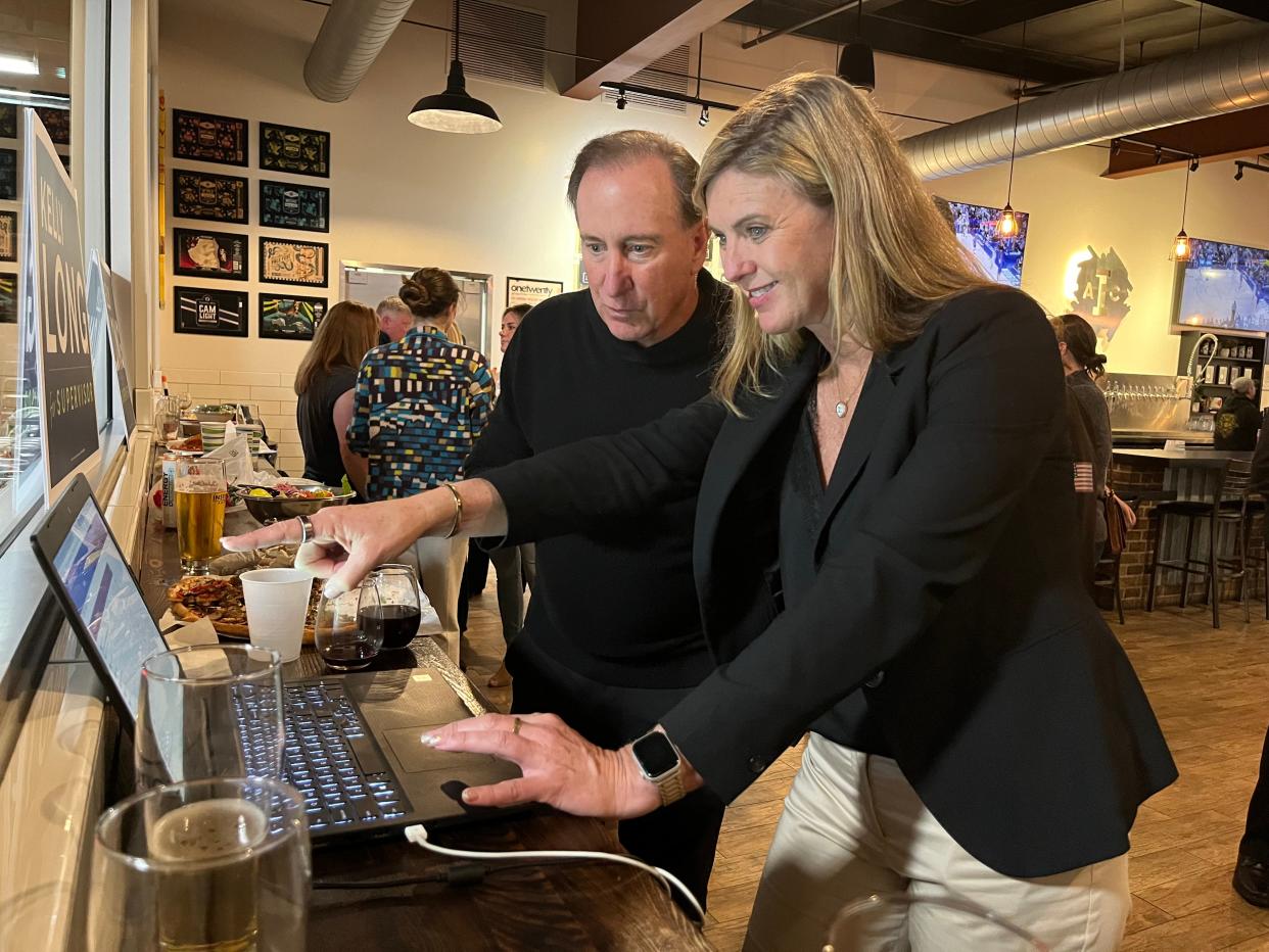 Ventura County Supervisor Kelly Long, with supporter John Scardino, checks the early returns in Tuesday's primary election at her campaign party at Institution Ale Co. in Camarillo. Long had a big lead in the first two rounds of results released Tuesday night.