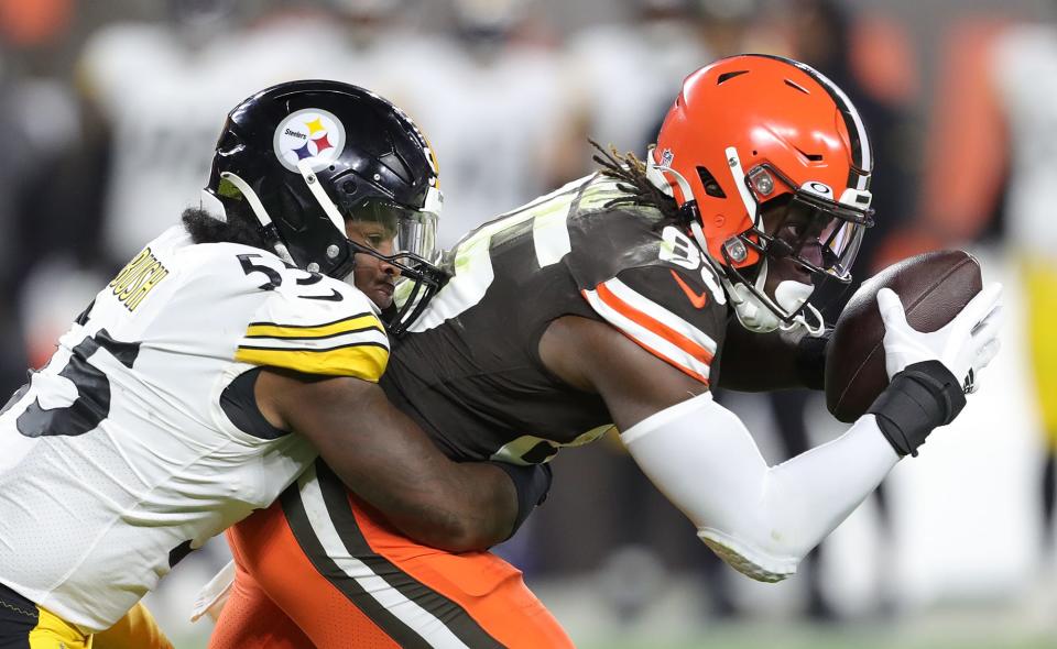 Browns tight end David Njoku is brought down by Steelers linebacker Devin Bush after gaining a first-half first down Thursday, Sept. 22, 2022, in Cleveland.