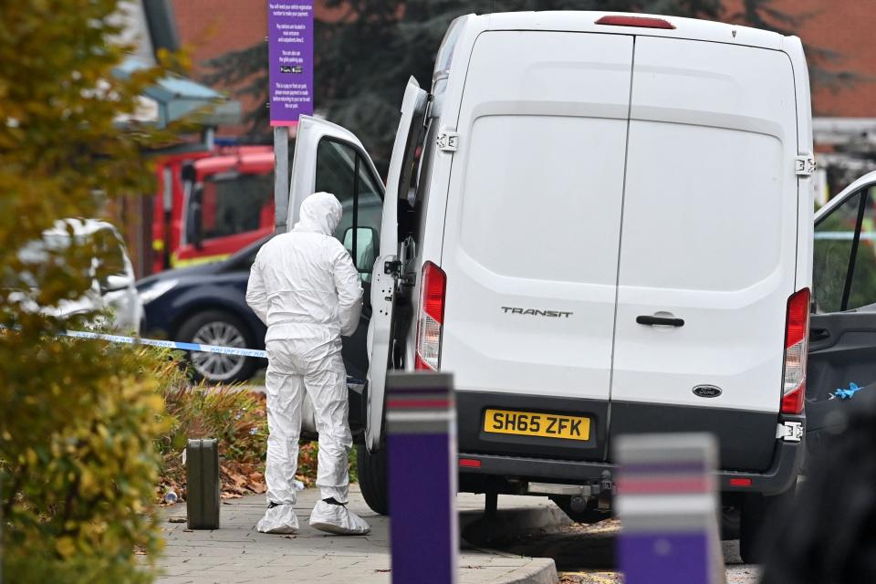 A specialist in a white suit arrives to inspect the scene outside the Women’s Hospital (AFP via Getty Images)