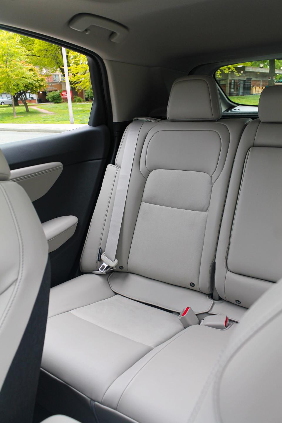 A close up of a rear white-leather seat in the 2023 Nissan Ariya Empower+ electric SUV.