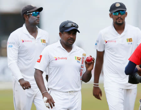 Cricket - Sri Lanka v South Africa -Second Test Match - Colombo, Sri Lanka - July 23, 2018 - Sri Lanka's Rangana Herath shows the ball to celebrate taking six wickets after Sri Lanka won the test series. REUTERS/Dinuka Liyanawatte/File Photo