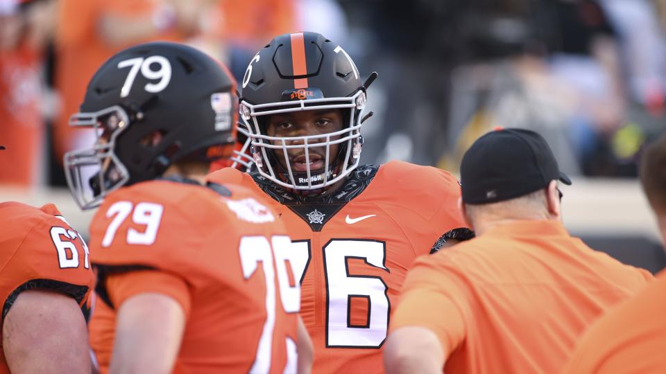 Oklahoma State offensive lineman Caleb Etienne warms up prior to a game Saturday, Oct. 30, 2021, in Stillwater, Okla. | Brody Schmidt, Associated Press