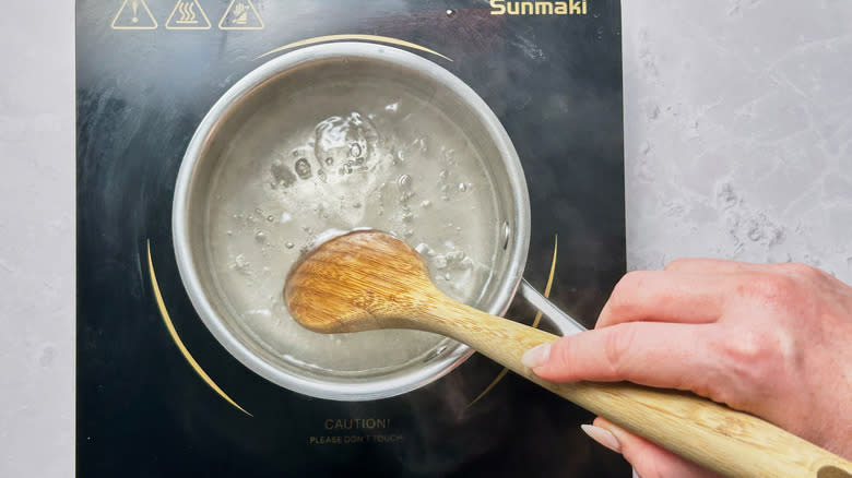 stirring sugar into water