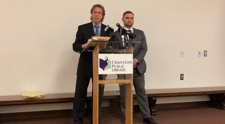 Attorneys Ken Schreiber and Chris Turco of Schreiber & Schreiber, representing the flooded-out former tenants of Dean Estates, speak at a Friday news conference at the Cranston Public Library.