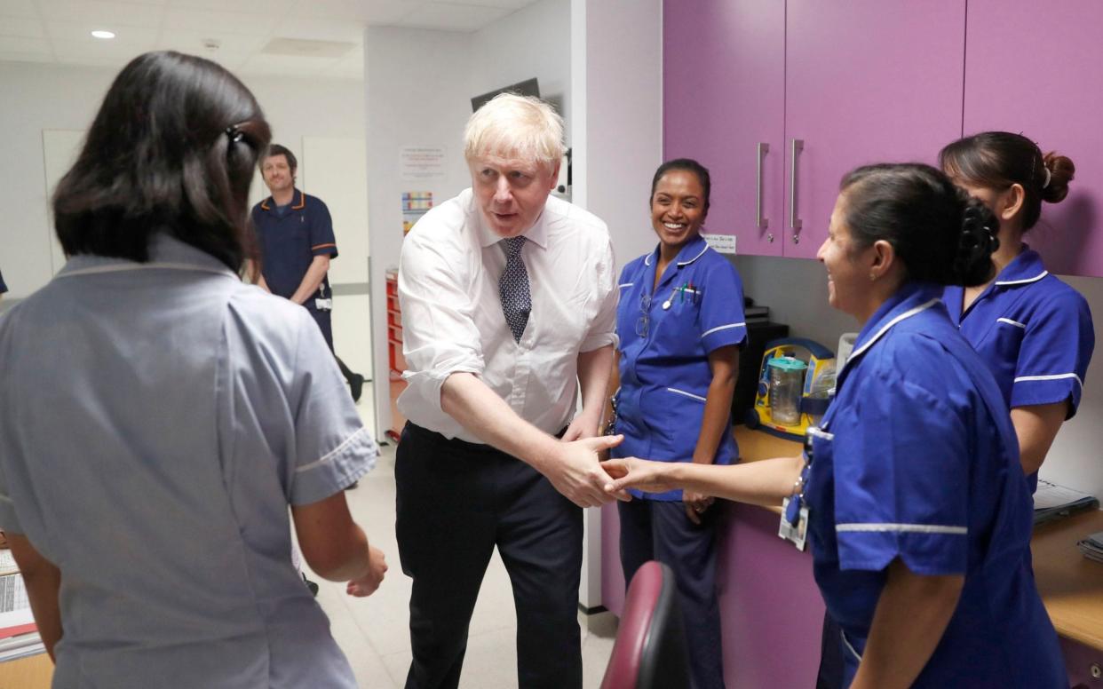 Prime Minister Boris Johnson speaks to nurses during a visit to the East Midlands and East of England Genomic Laboratory Hub at Addenbrooke's Hospital in Cambridge - PA