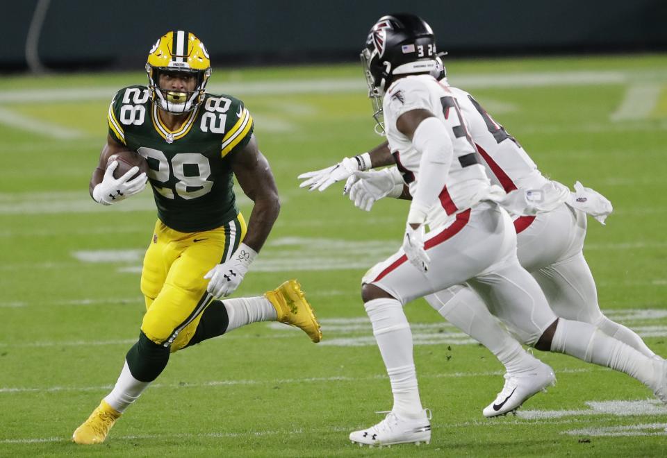 Green Bay Packers running back A.J. Dillon looks to get past the Atlanta Falcons defense on Oct. 5, 2020, at Lambeau Field in Green Bay.