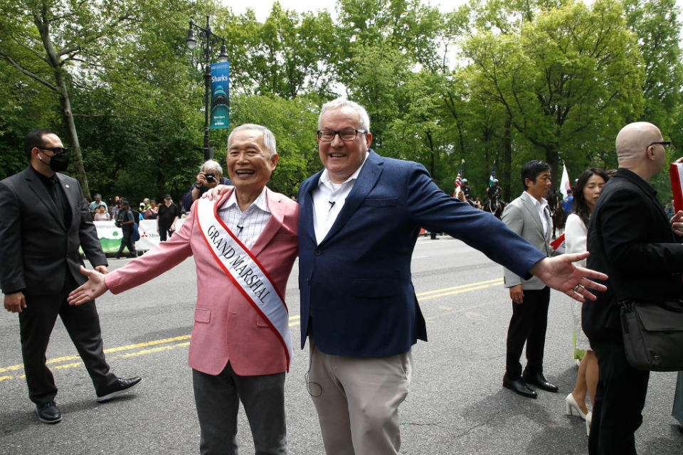 George and Brad Takei standing on the street at a public event