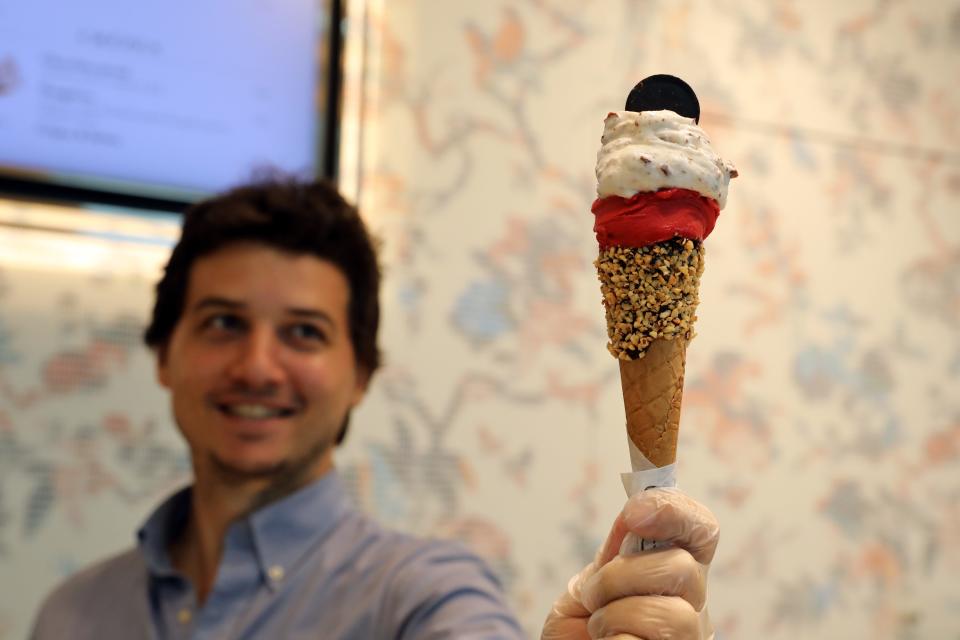 Michele Sbarigia, the retail operations manager at Venchi, holds a raspberry and stracciatella gelato at the new shop in The Westchester in White Plains Sept. 5, 2023. 