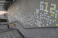 Stickers with messages supporting protesters are left on a wall near the Legislative Council in Hong Kong on Friday, June 14, 2019. Calm appeared to have returned to Hong Kong after days of protests by students and human rights activists opposed to a bill that would allow suspects to be tried in mainland Chinese courts. (AP Photo/Vincent Yu)