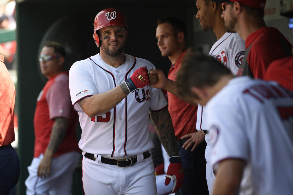 Washington Nationals' Matt Adams, front left, continues to celebrate his three-run home run in the dugout during the first inning of a baseball game against the Milwaukee Brewers, Sunday, Aug. 18, 2019, in Washington. (AP Photo/Nick Wass)