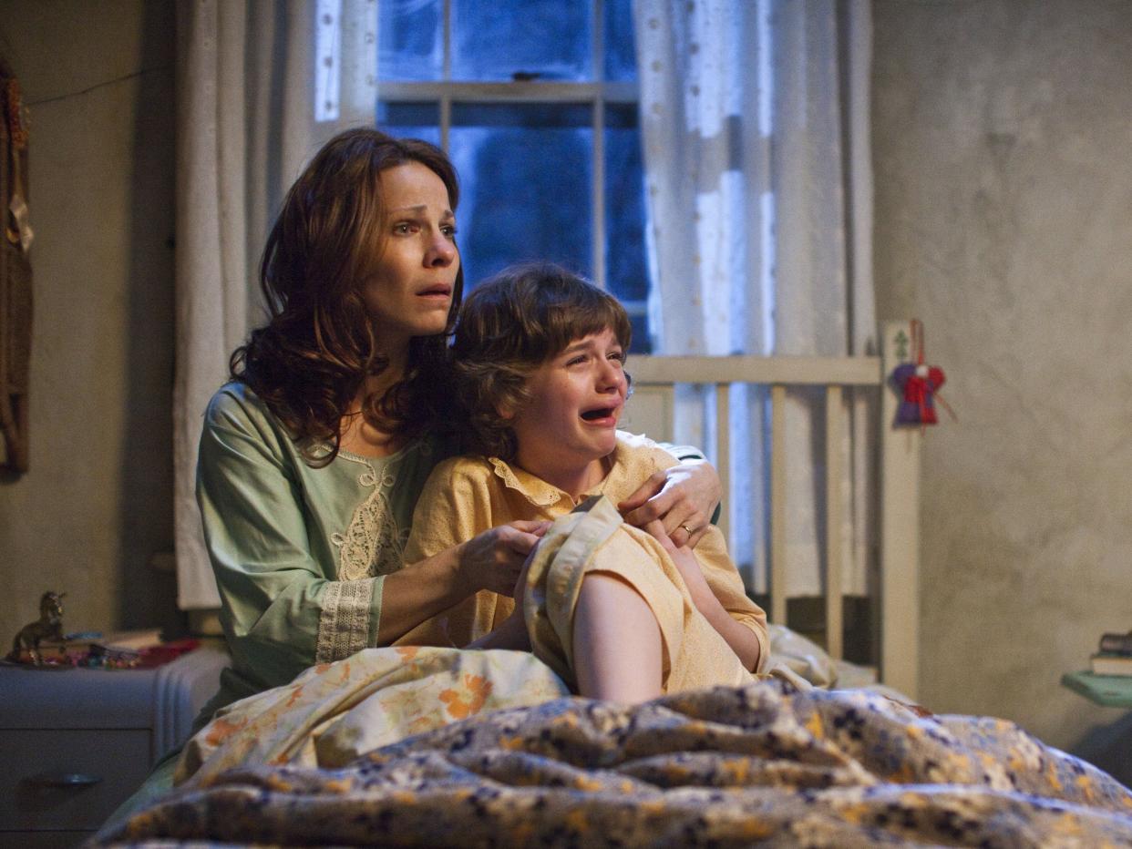 Lili Taylor and Joey King in the 2013 horror movie 'The Conjuring' (Warner Bros)