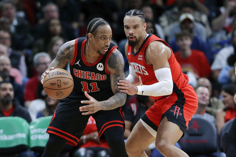 Chicago Bulls forward DeMar DeRozan (11) looks to drive around Houston Rockets forward Dillon Brooks, right, during the first half of an NBA basketball game Thursday, March 21, 2024, in Houston. (AP Photo/Michael Wyke)