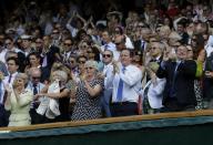 Prime Minister David Cameron (centre) applauds in the Royal Box near Scottish First Minister Alex Salmond (right) as Great Britain's Andy Murray plays Serbia's Novak Djokovic in the Men's Final during day thirteen of the Wimbledon Championships at The All England Lawn Tennis and Croquet Club, Wimbledon.