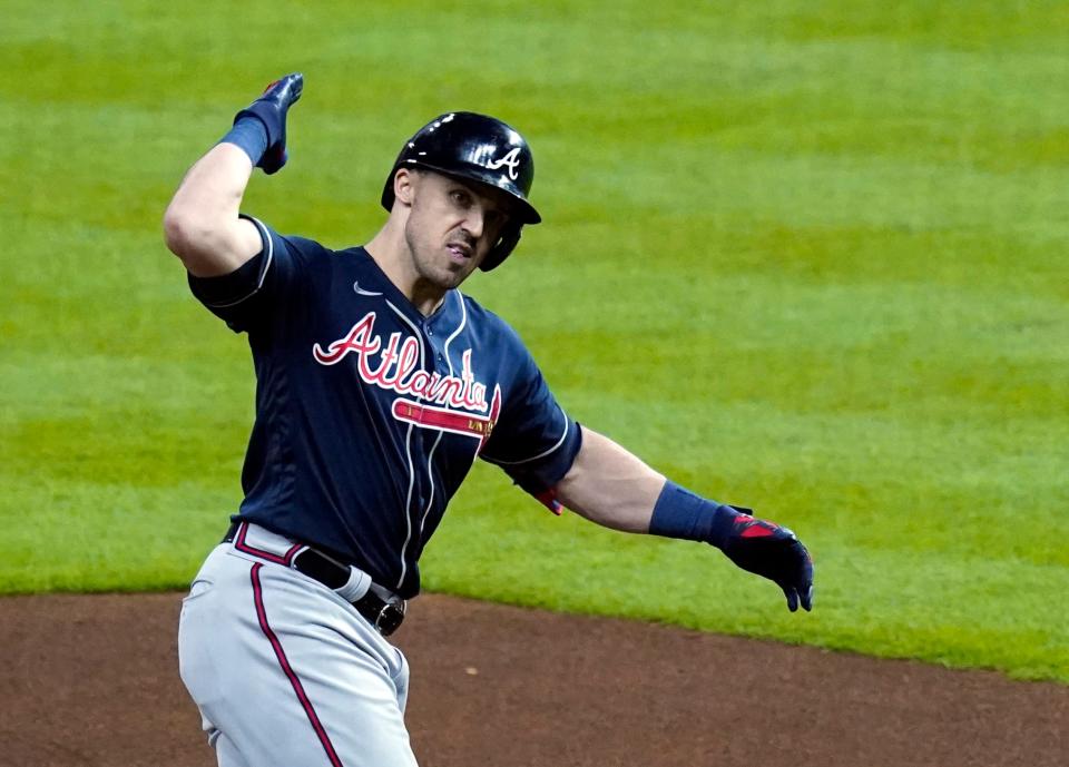 Braves center fielder Adam Duvall rounds the bases after his two-run home run.