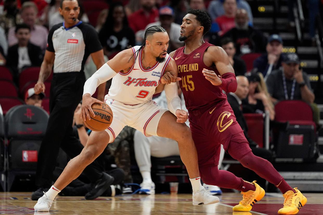 Houston Rockets' Dillon Brooks (9) works for position against Cleveland Cavaliers' Donovan Mitchell (45) on Saturday in Houston.