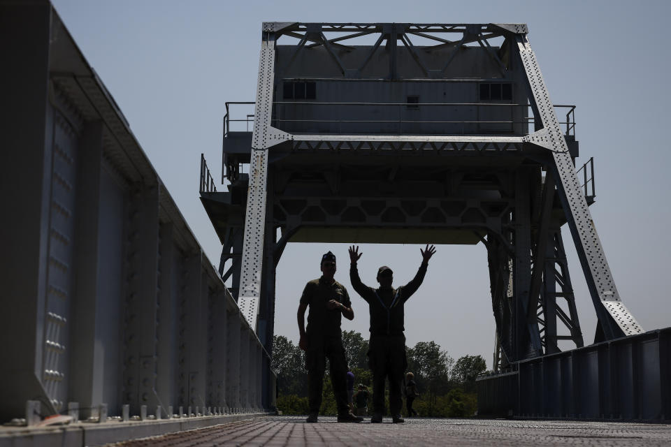 Servicemen walk on Pegasus Bridge, one of the first sites liberated by Allied forces from Nazi Germany, in Benouville, Normandy, Monday June 5, 2023. Dozens of World War II veterans have traveled to Normandy this week to mark the 79th anniversary of D-Day, the decisive but deadly assault that led to the liberation of France and Western Europe from Nazi control. (AP Photo/Thomas Padilla)