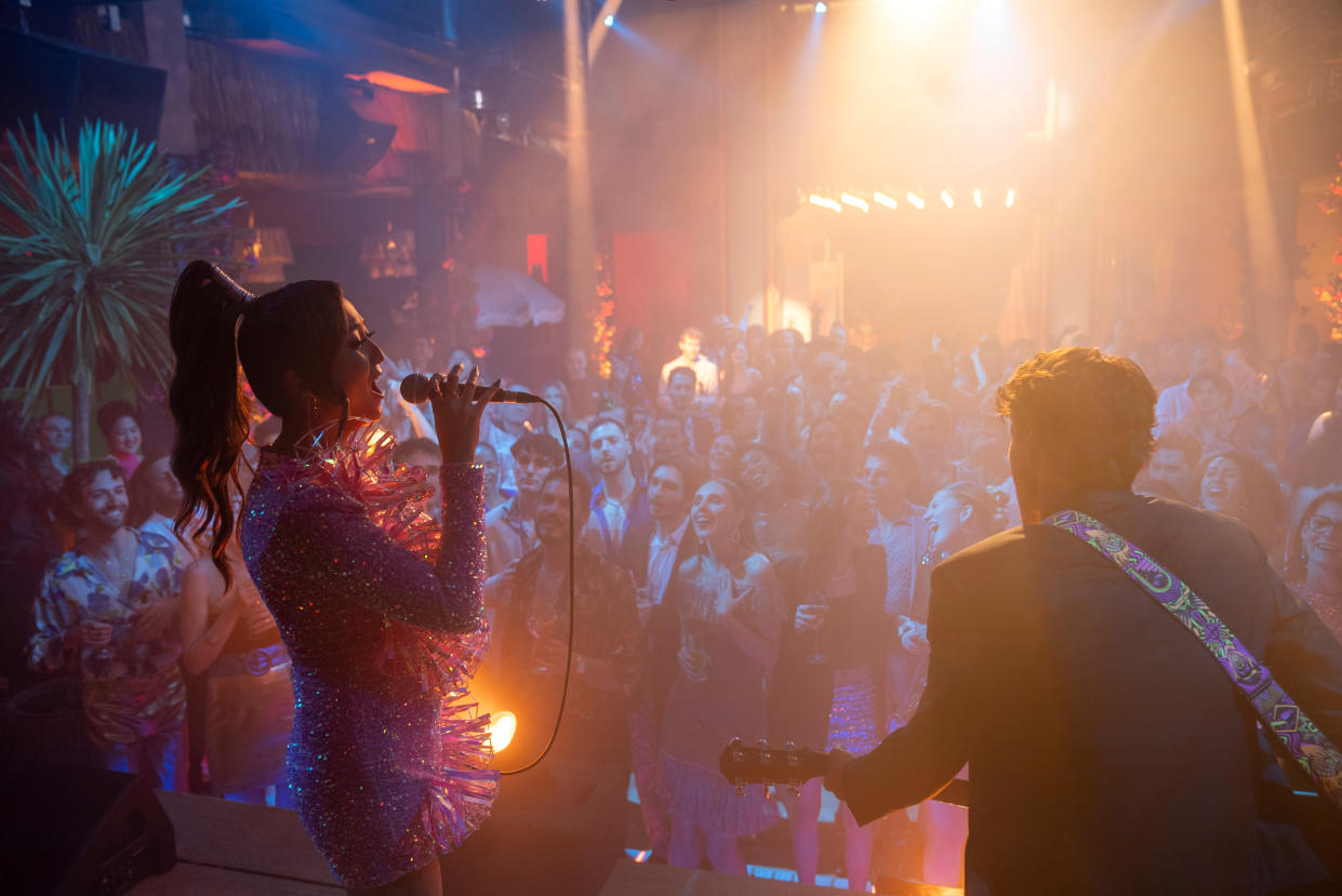 Mindy playing with her band in Emily In Paris