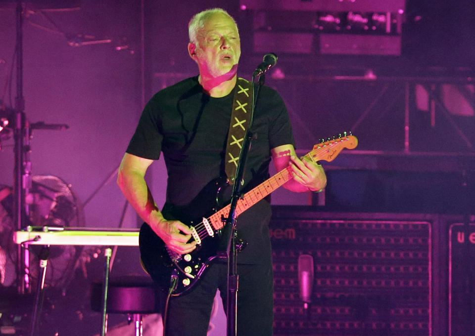 FILE - In this July 7, 2016, file photo, musician David Gilmour performs in the ancient roman amphitheater of the Pompeii archeological site, Italy. Christie’s auction house says it raised $21.5 million Thursday, June 20, 2019, selling off more than 120 guitars owned by the Pink Floyd guitarist, singer and songwriter. Proceeds went to ClientEarth, a non-profit fighting climate change. A black Stratocaster, dubbed the “Black Strat”, was the top item and was snatched up for $3,975,000, a new world record for a guitar at auction. (AP Photo/Gregorio Borgia, File)