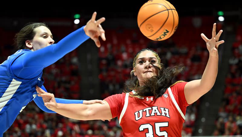 BYU Cougars forward Emma Calvert (25) tries to deflect the ball from Utah Utes forward Alissa Pili (35) as Utah and BYU women play at the Huntsman Center in Salt Lake City on Saturday, Dec. 2, 2023.