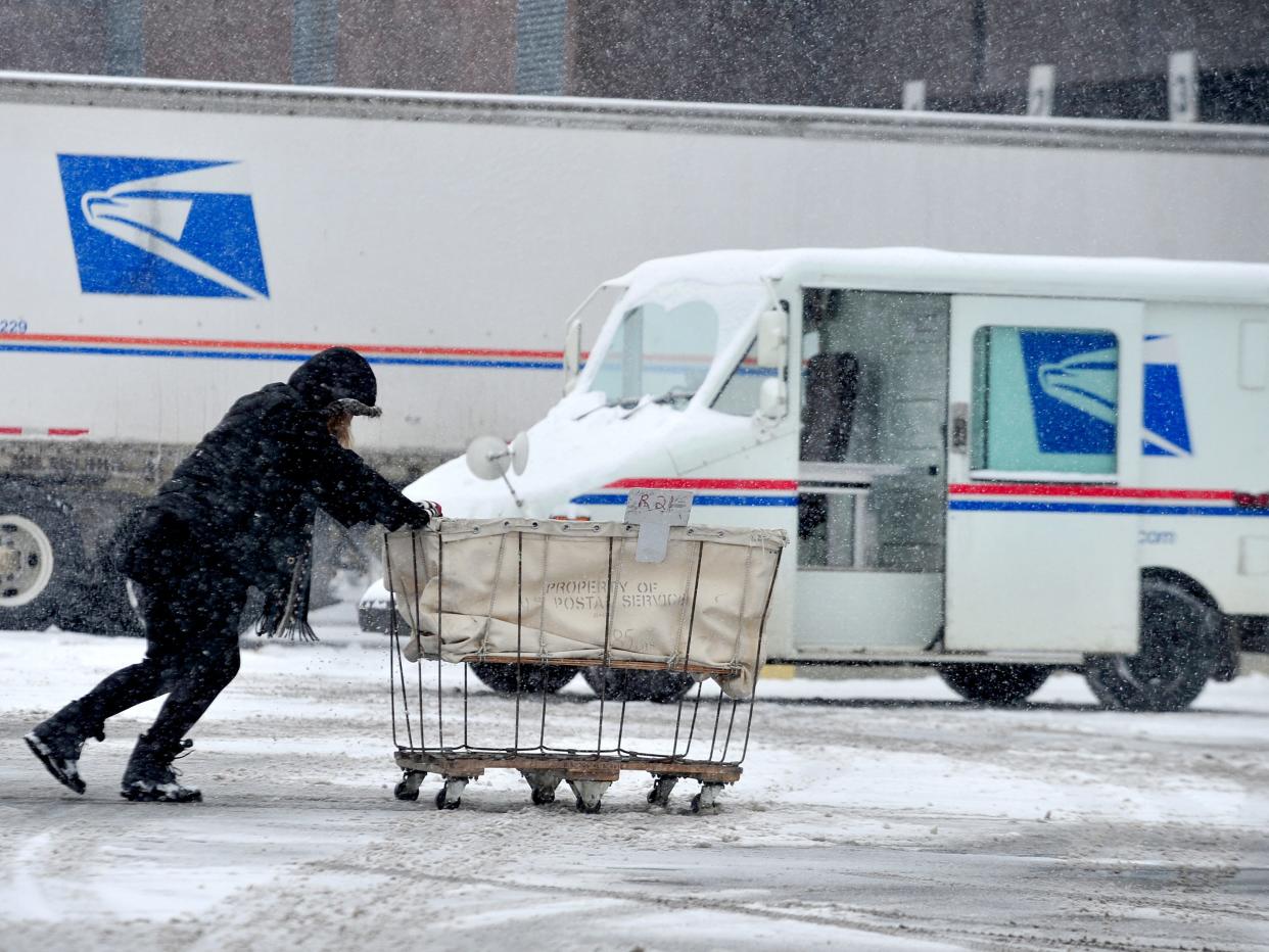USPS mailman delivering in storm