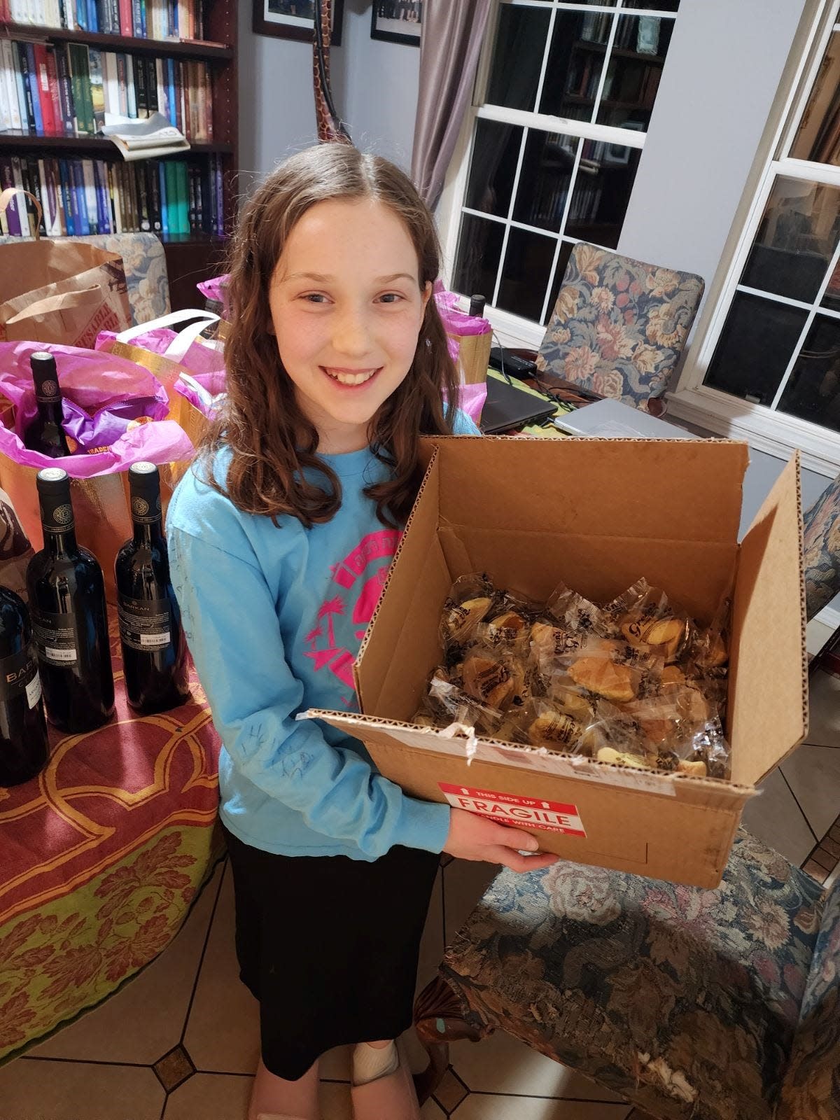 Rabbi Mendel Lifshitz's daughter poses with a surprise box of hamantaschen cookies left on the doorstep of his Chabad center in Boise. "We feel quite strongly that our non-Jewish neighbors, by-in-large, have stepped up to demonstrate their support," he says.
