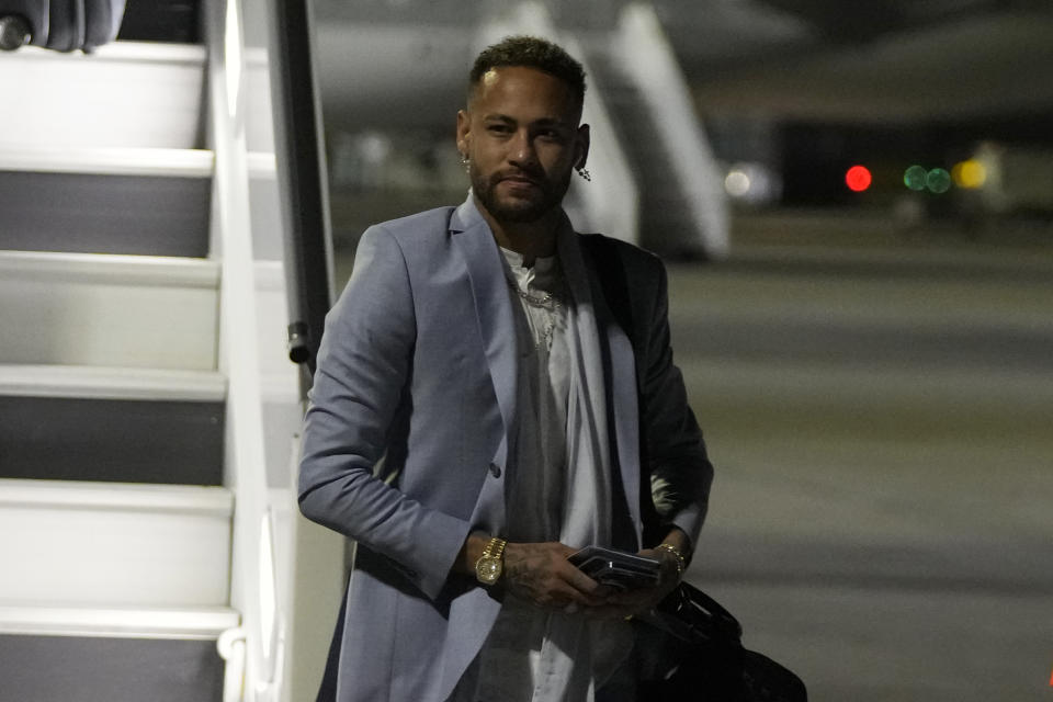 Brazil's Neymar gestures as arrives with teammates at Hamad International airport in Doha, Qatar, Saturday, Nov. 19, 2022 ahead of the upcoming World Cup. Brazil will play the first match in the World Cup against Serbia on Nov. 24. (AP Photo/Hassan Ammar)