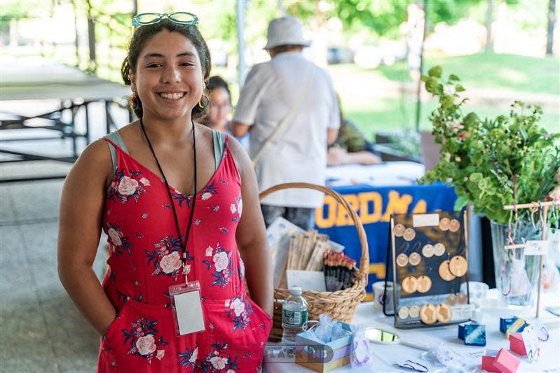 Giselle Dos Reis, 12, of New Bedford, stands with her handmade jewelry for sale at the Dream Makers Market on Thursday, July 14, at Wing's Court in downtown New Bedford.