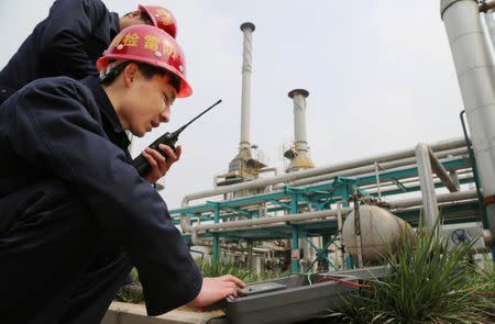 Employees work inside a factory of Pingmei Shenma Group in Baofeng County, Henan province, China, April 8, 2015. Picture taken April 8, 2015. China Daily/via REUTERS