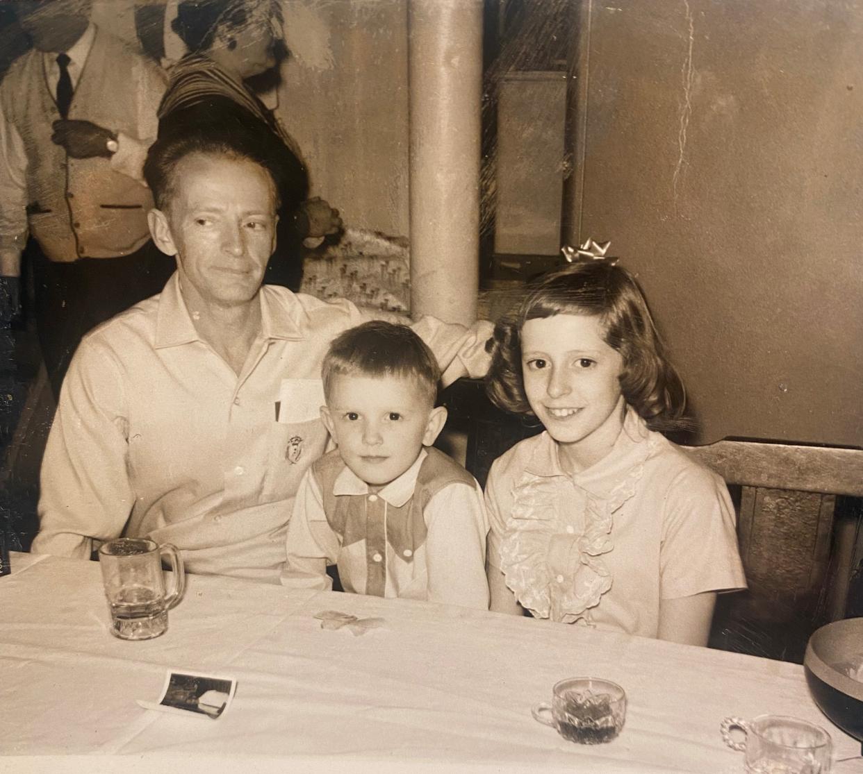 Freelance writer Jill Sell is pictured with her father, Charles F. Veleba, and little brother, Charles M. Veleba, in a photo taken during a holiday party at her aunt's home. Sell's father died when she was a freshman in college. He has battled the effects of polio most of his life. Sell's brother died a year ago from COVID-19.