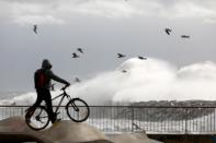 Man looks at sea waves during the storm "Gloria" on Barceloneta beach, in Barcelona