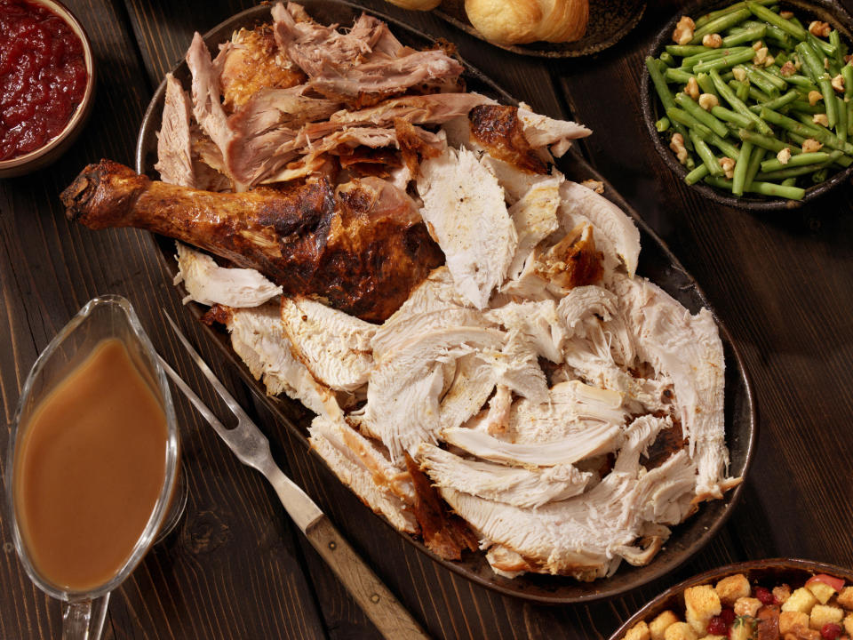 A carved turkey and side of gravy