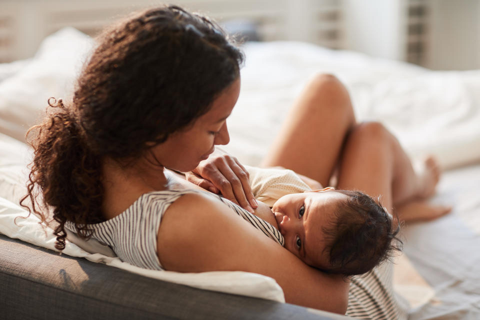 Portrait of mother breastfeeding baby represents debate over breast milk jewellery 