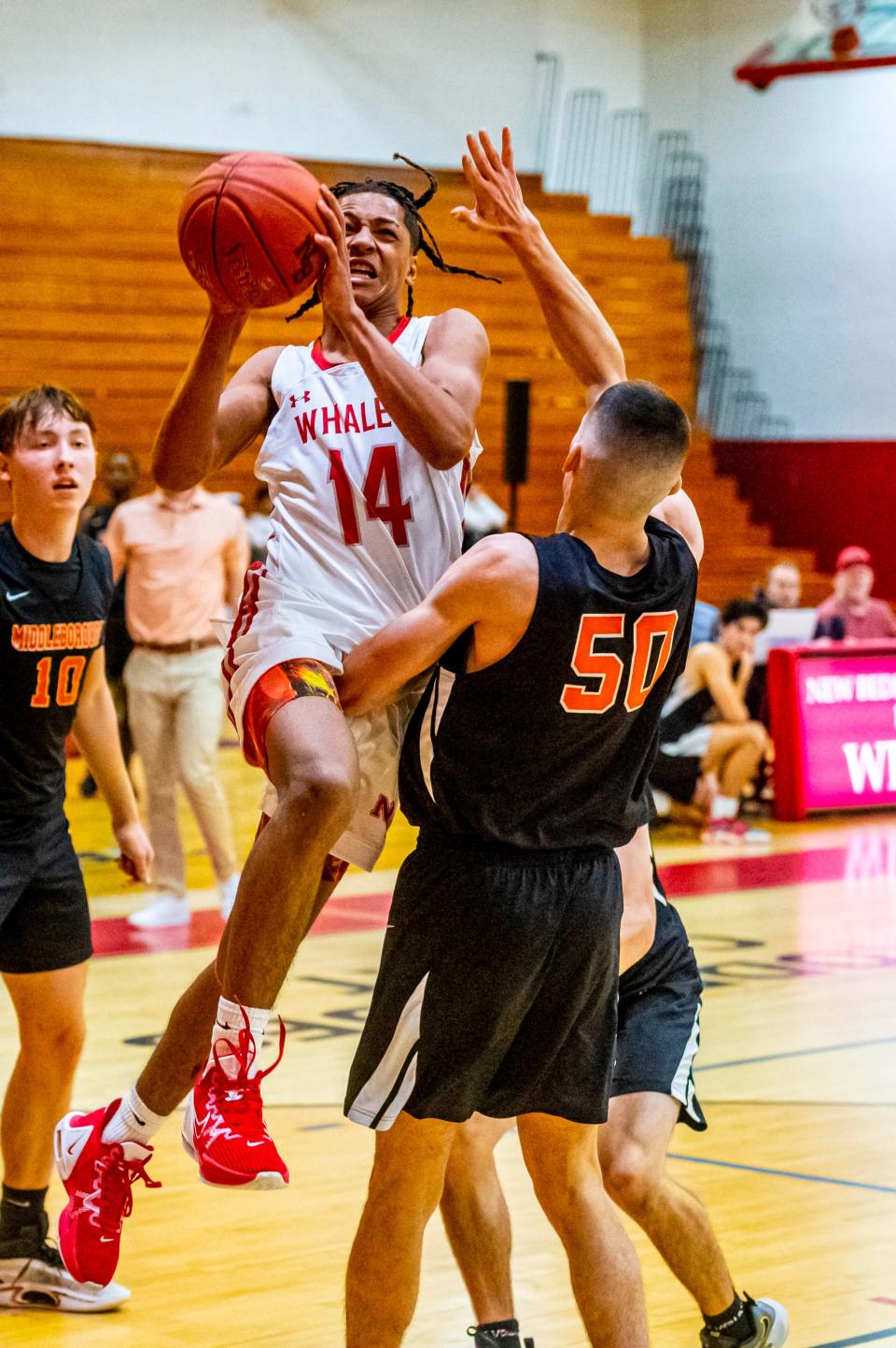 New Bedford's Damarius Roberts draws the foul on this drive to the basket.