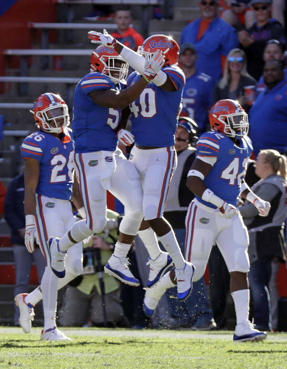 Florida linebacker Ventrell Miller, center left, celebrates after returning an 82-yard interception for a touchdown against Idaho with linebacker Nick Smith (40) during the second half of an NCAA college football game, Saturday, Nov. 17, 2018, in Gainesville, Fla. (AP Photo/John Raoux)