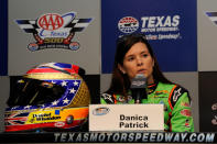 FORT WORTH, TX - NOVEMBER 04: Danica Patrick, driver of the #7 GoDaddy.com /DanWheldonMemorial.com Chevrolet, speaks at a press conference announcing her donation to the auction benefitting the Dan Wheldon Family Trust Fund following practice for the NASCAR Nationwide Series O'Reilly Auto Parts Challenge at Texas Motor Speedway on November 4, 2011 in Fort Worth, Texas. Patrick's last IndyCar race was the race in which Wheldon was killed. She said safety was not the reason she is switching from IndyCar to NASCAR, though she said she does feel safer in a stock car. (Photo by John Harrelson/Getty Images for NASCAR)