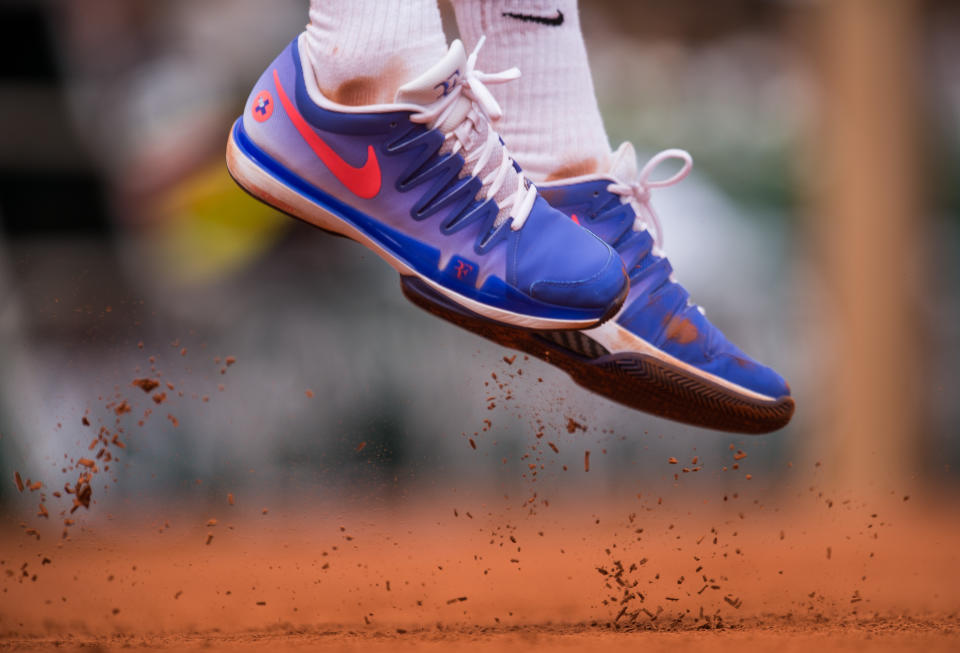 Roger Federer Nike shoes kick off the clay as he serves the ball during his 1st round men's singles match against Alejandro Falla on day one of the French Open at Roland Garros on May 24, 2015 in Paris, France